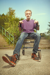 Older man overcoming obstacles with his four wheel rollator walker