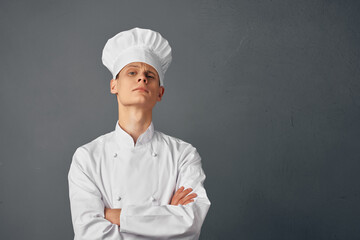 Cheerful chef folded his hands in front of him uniform work