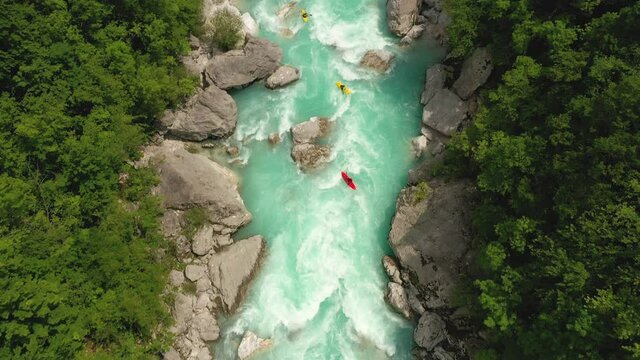 Aerial - Kayaks on a beautiful turquoise Soča river going underneath a bridge