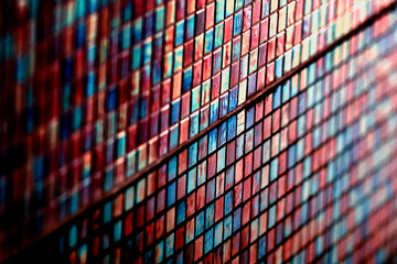 Colored rectangled tiles mainly blue and pink with a mirror reflection tilt shift blur