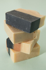 tower stack of different handmade soaps isolated on color background 

