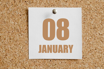 january 08. 08th day of the month, calendar date.White calendar sheet attached to brown cork board.Winter month, day of the year concept