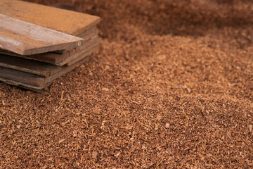 Brown sawdust piles on the floor, which is caused by wood decoration.