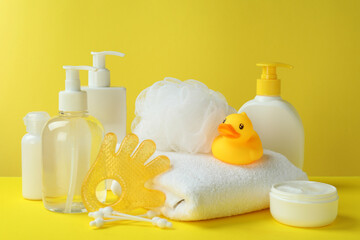 Fototapeta na wymiar Different baby hygiene accessories on yellow background