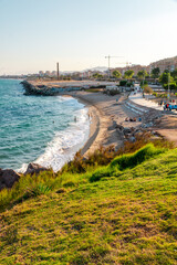 Montgat beach picture captured from a high point of view during golden hour. Mountains near the...