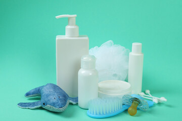 Different baby hygiene accessories on mint background