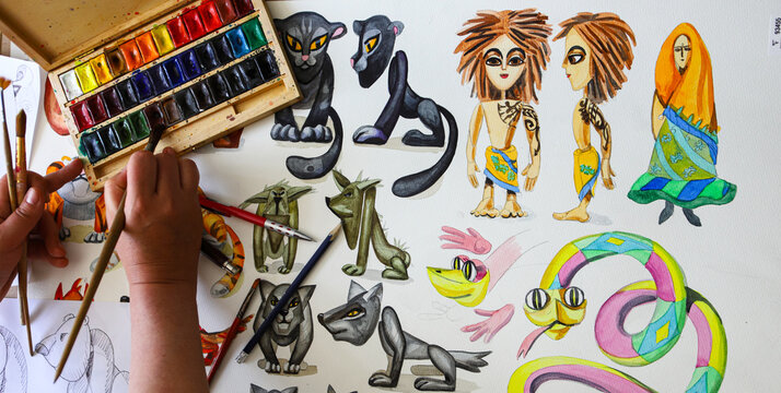 The animator draws with a pencil and draws characters from cartoons, comics or puppet shows. Mowgli's play. Preparing to make a doll. The designer creates sketches. Comics, cartoons, puppet theater
