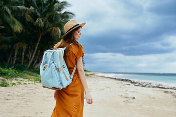 woman with backpack on the beach island travel walk