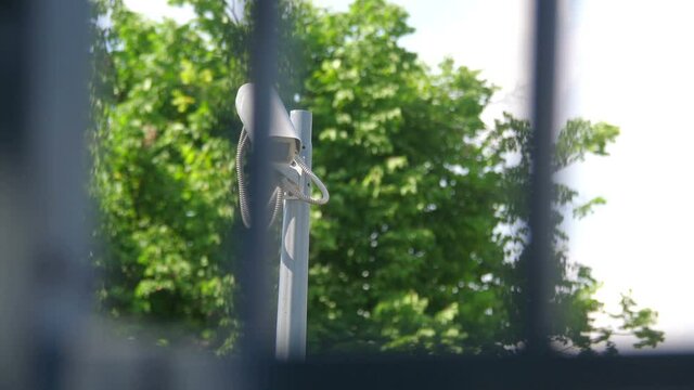 Security camera behind the fence in 4k slow motion 60fps