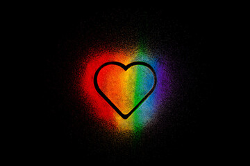Colorful rainbow heart made of colored sands on black background