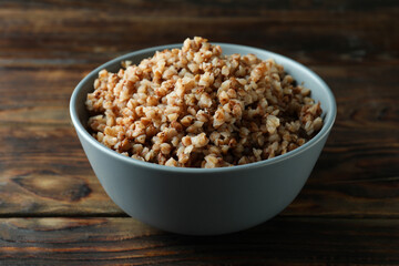 Bowl of tasty buckwheat on wooden table