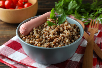 Concept of tasty eating with buckwheat on wooden table