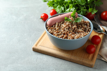 Concept of tasty eating with buckwheat on gray textured table