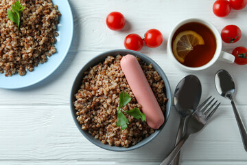 Concept of tasty eating with buckwheat on wooden table