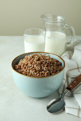 Concept of tasty eating with buckwheat on white textured table