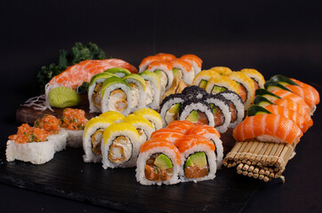 large sushi combo with salmon and shrimp over black background