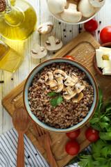 Concept of tasty eating with buckwheat on wooden table