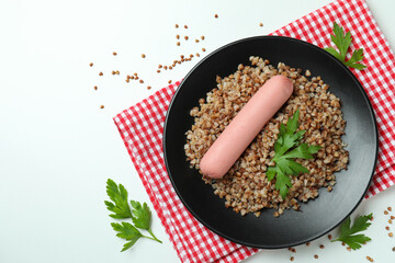 Concept of tasty eating with buckwheat on white background