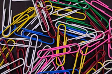 Colorful paper clips  on black background