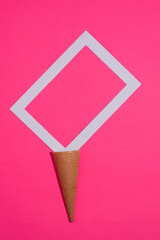 Minimum summer concept. Ice cream cone with a white frame on a purple background. 