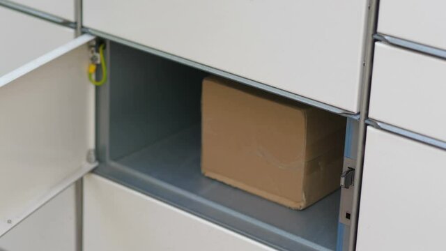 Putting a parcel to a parcel locker in 4k slow motion 60fps