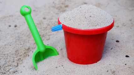 Sand toys with shovel and bucket in a sandpit