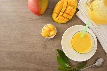 Background with table with mango juice and fruit top view