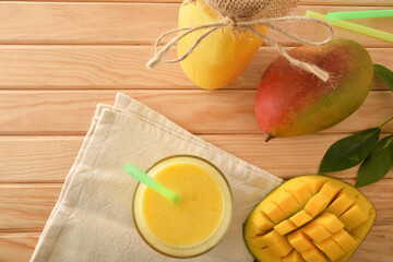 Mango juice with fruit on wooden table top view