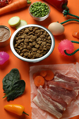 Concept of organic pet food on orange background