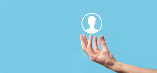 Hand holds user person icon interface on blue background.User symbol for your web site design, logo, app, UI.Banner