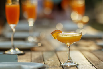 glass of champagne on the wooden table with bokeh light background