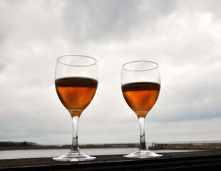 Two glasses of beer by the water