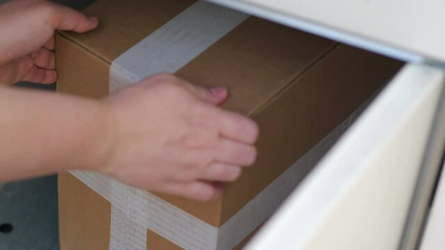 Taking out a parcel from a parcel locker in 4k slow motion 60fps