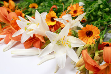 Fototapeta na wymiar A beautiful set of flowers from white and orange lilies to collect a bouquet florist.