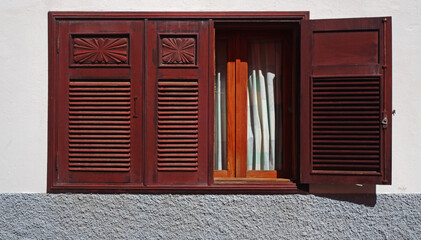 window with red carved shutter, San Sebastian, Canary islands