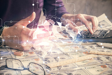 Double exposure of man's hand holding and using a digital device and brain hologram drawing. Data...