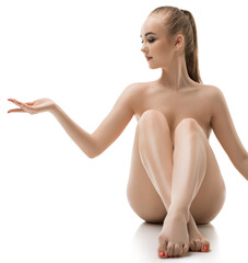 Obraz premium Nude graceful blonde sitting alone isolated shot