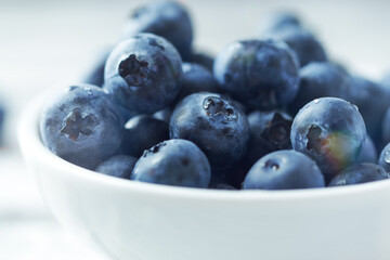 Bilberries on bright wooden background. Close up. 