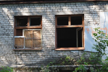 Ruined houses and old dilapidated buildings, houses with broken windows. Consequences of explosions and shooting.