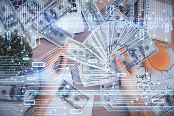Multi exposure of technology drawing hologram and us dollars bills and man hands. Data concept