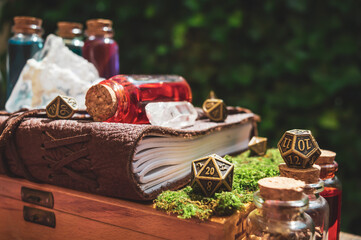 image of a leather-bound book and metallic RPG dice