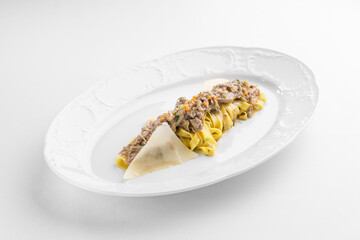 Fettuccine pasta with chicken and cheese on white plate isolated on white background