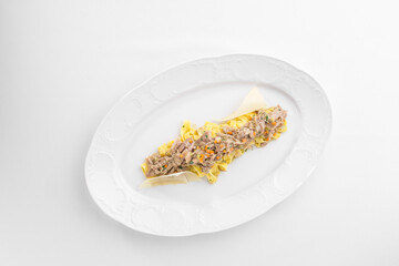 Fettuccine pasta with chicken and cheese on white plate isolated on white background