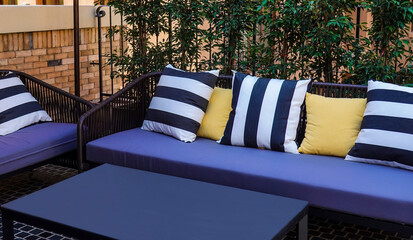 Decoration of comfortable pillows decorate on sofa in the garden background