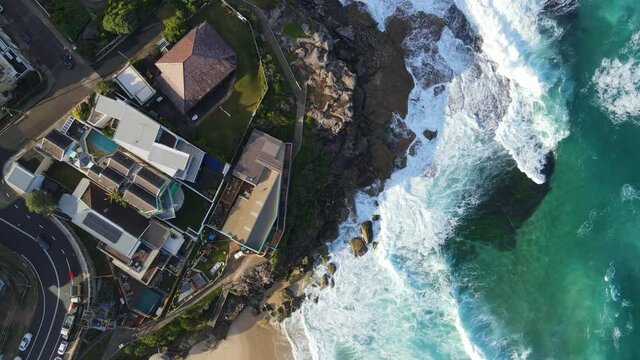 Top View Of Waves Breaking Against Tamarama Point And Beach - Scenic Spot At Tamarama, NSW, Australia. - aerial