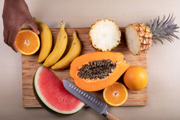 some fresh tropical fruit on the table ready to be cut and prepared for a smoothie