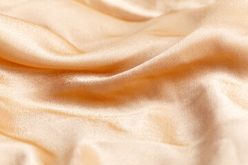 texture of golden silk fabric with folds, background