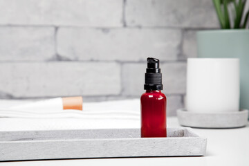 Face serum bottle on table at home bathroom. Minimal styling. Beauty blogging, skin care ad mock up with copy space