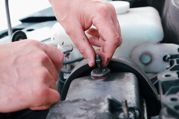Car repair. Auto mechanic working on car engine in mechanics garage. Repair service. close-up shot