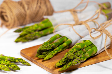 Asparagus. Fresh Green asparagus in wooden basket on white background. Healthy vegetable diet. Vegetarianism. Vegetable wallpaper.